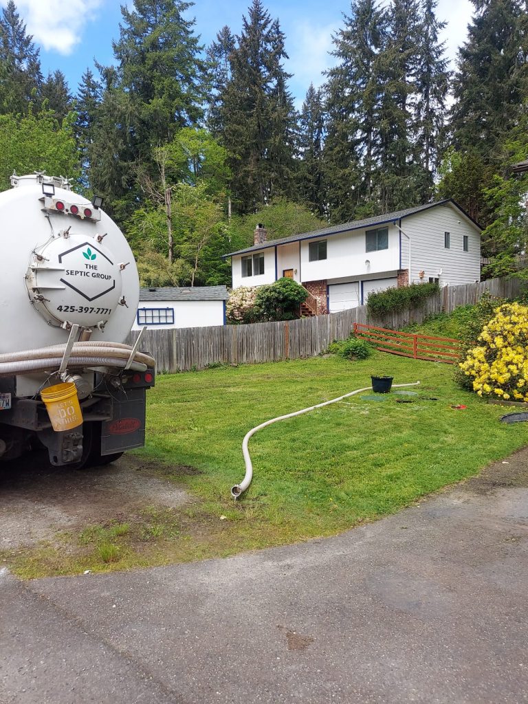 Sewage cleaning workers equipment with sewer on a town street.
